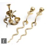 A pair of brass wall sconce candle holders modelled as stylised cobras, length 46cm, together with