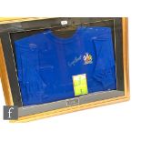 A framed blue shirt ECF Wembley 1968 signed by George Best, with insert photograph of the player