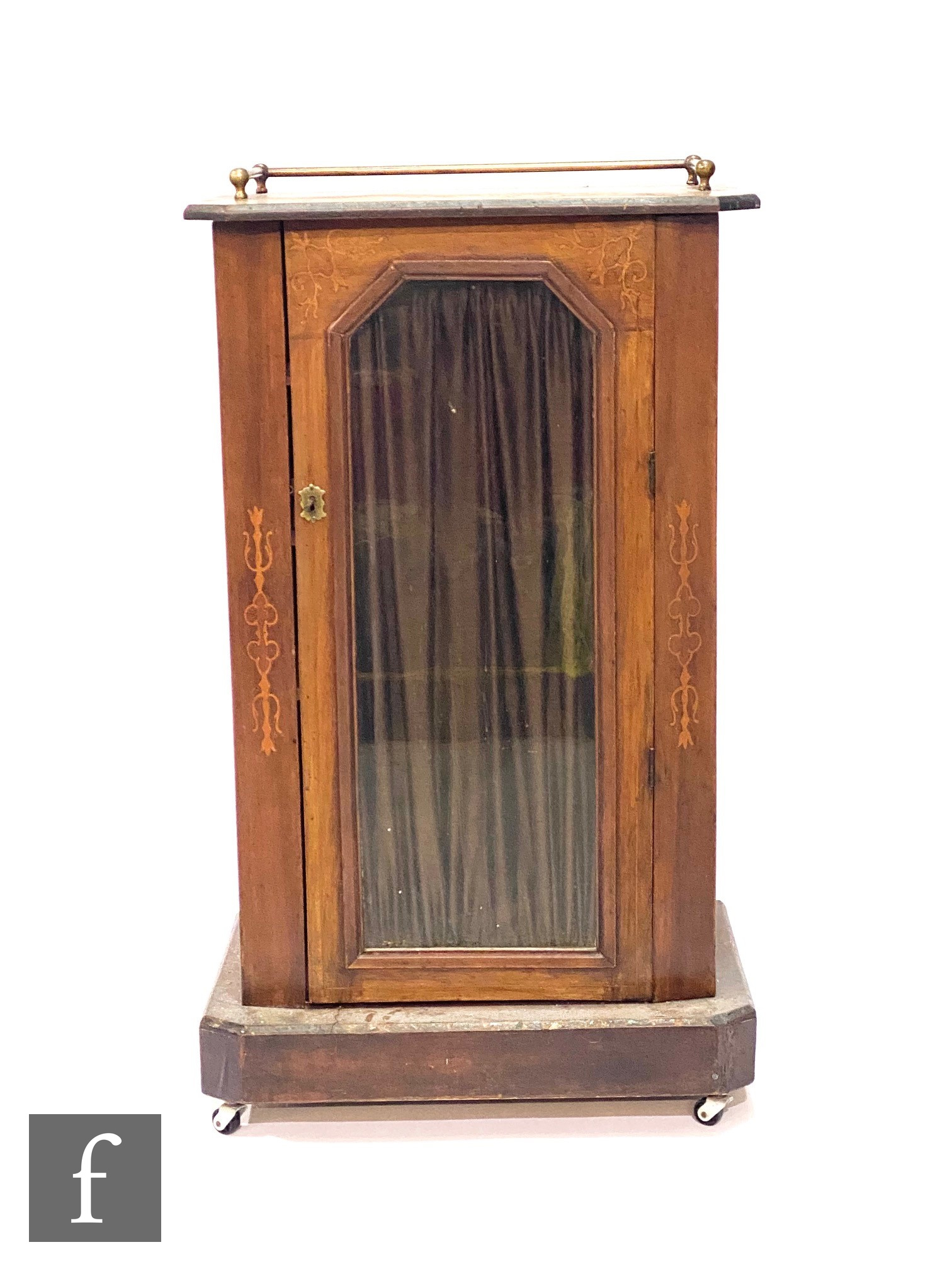 A small Victorian marquetry inlaid music or pier cabinet enclosed by a curtained glazed door below a