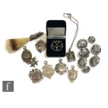 Five silver 1920s amateur league silver cricket fobs, a locket with a stump, bat and ball, a