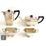 A hallmarked silver Art Deco four piece pedestal tea set of plain faceted boat shaped form,