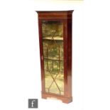 An Edwardian mahogany corner display cabinet with chequer inlaid cornice above a single astragal