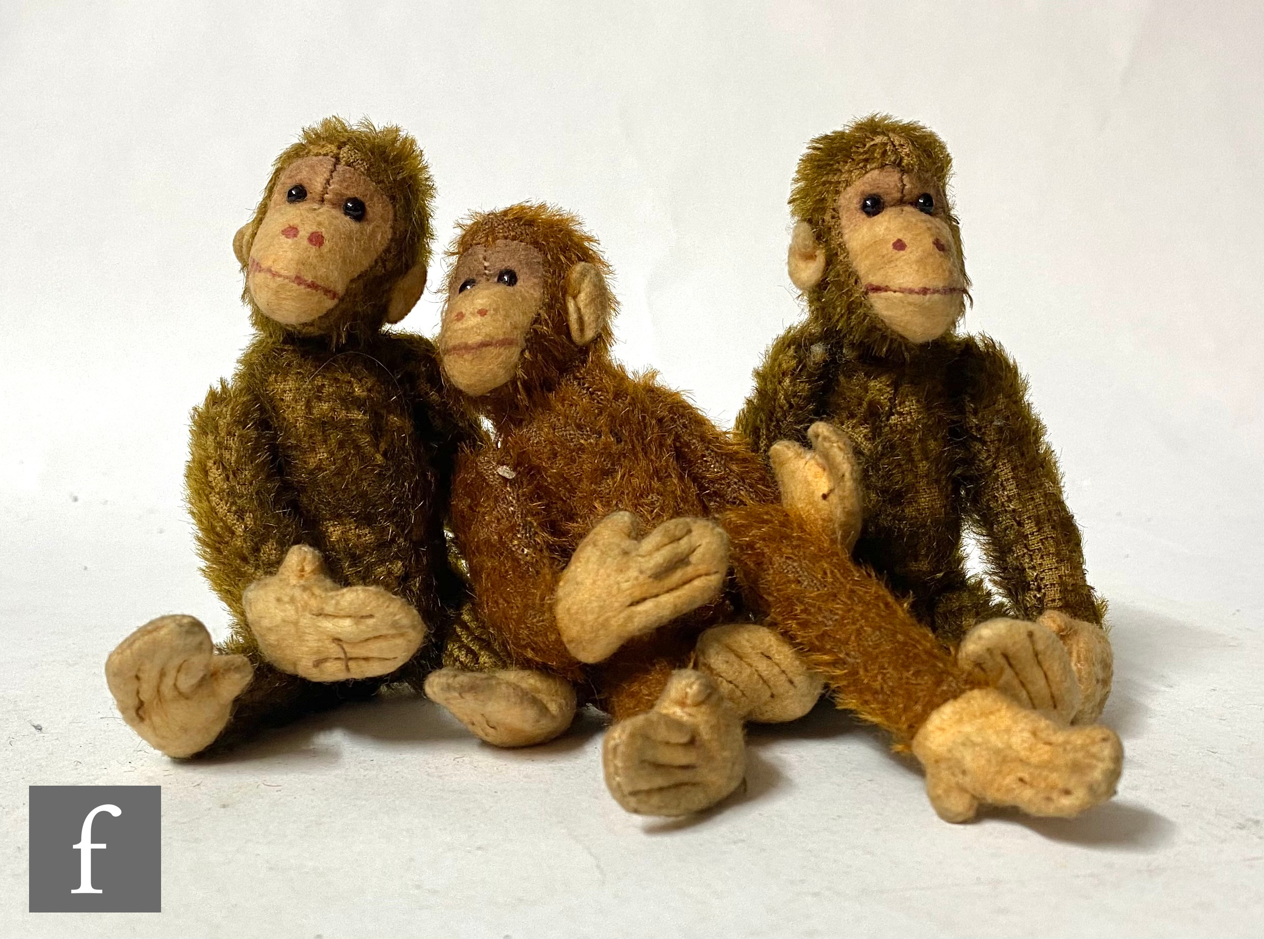 Three British monkeys, two in brown mohair, one in cinnamon, each with felt faces, hands and feet,