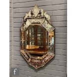A Venetian style octagonal wall mirror, the panelled border etched with a floral design mounted with