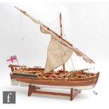 A 20th Century wooden scale model of a single master sloop fitted with a single brass canon and