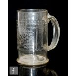 A large 18th Century continental tankard of footed cylindrical form with an attached wide band