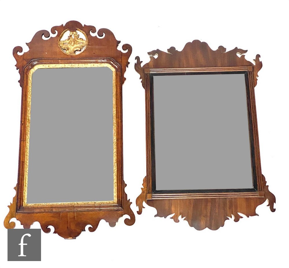 An early 19th Century Chippendale style parcel gilt mahogany wall mirror, the rectangular plate