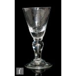 An early 18th Century heavy baluster goblet circa 1710, the round funnel bowl supported by a