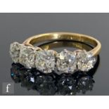 An 18ct diamond five stone ring, graduated claw set old cut stones, total weight approximately 2.