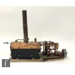 A vertical twin cylinder live steam marine engine with horizontal wood lagged boiler and