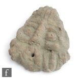 A French medieval carved stone head of a crowned male with bulging eyes and holed mouth, possibly