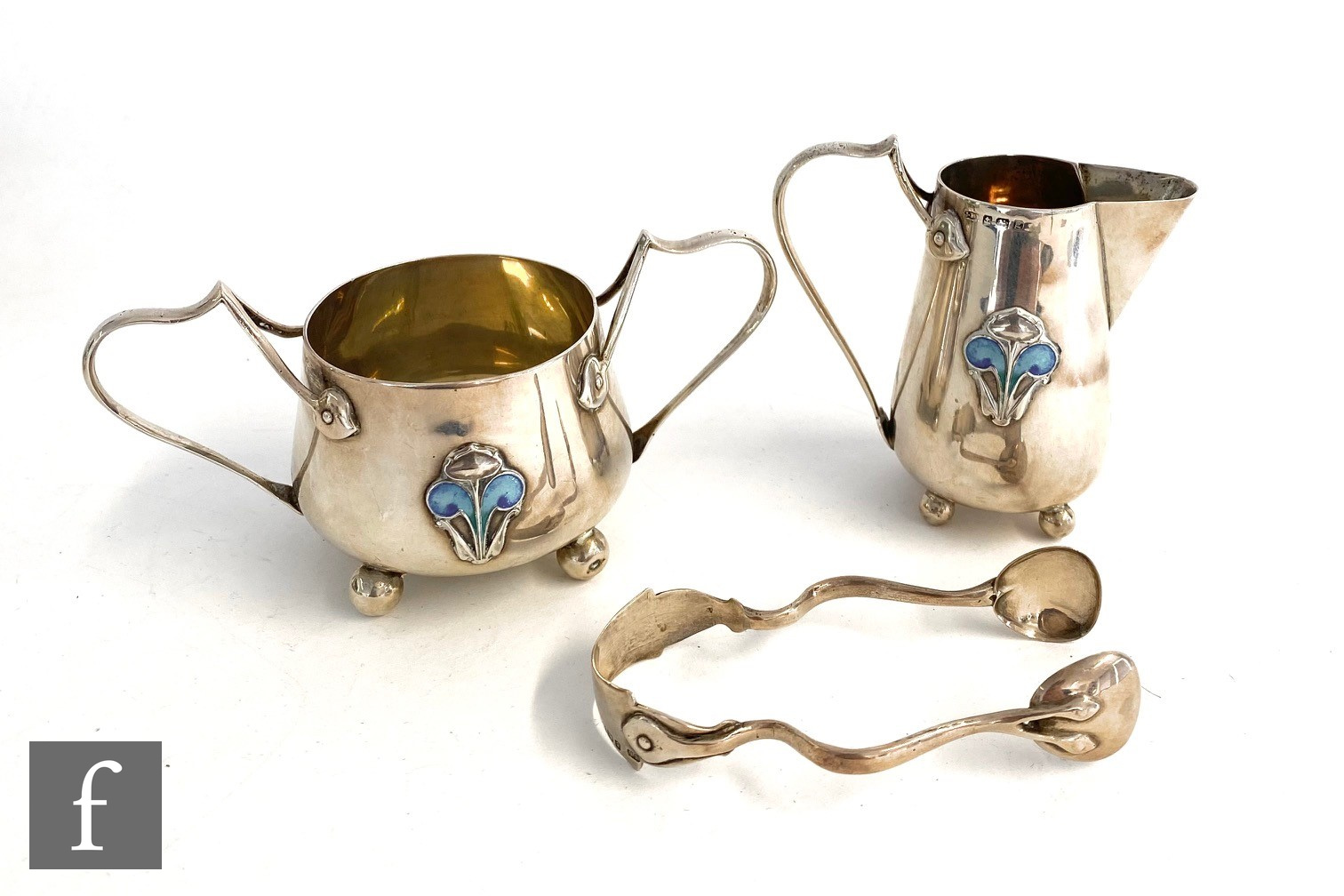 An Art Nouveau hallmarked silver strawberry set comprising cream jug, height 8cm, and twin handled