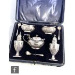 A cased hallmarked silver five piece, boat shaped cruet set each with part fluted decorations, total