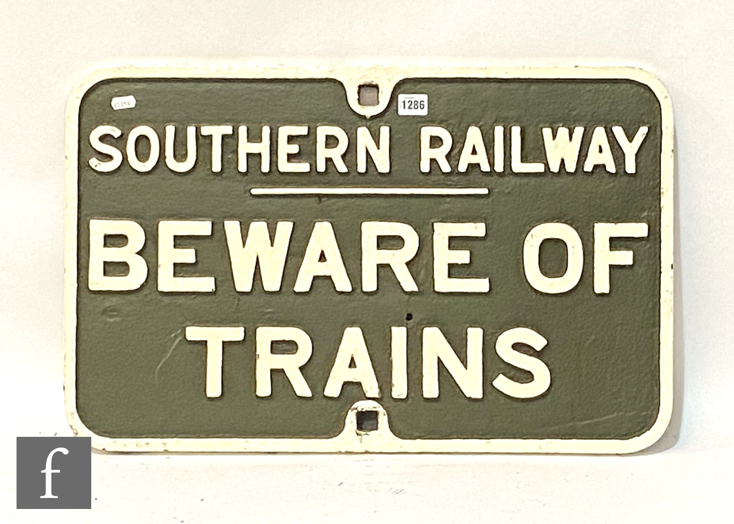 A cast iron Southern Railway sign 'Beware of Trains', white lettering on dark green, 42cm x 66cm.