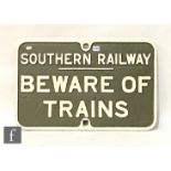 A cast iron Southern Railway sign 'Beware of Trains', white lettering on dark green, 42cm x 66cm.
