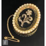A 19th Century 9ct diamond and split pearl oval memorial brooch with central diamond set floral