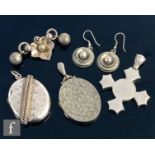 Five items of late 19th Century white metal jewellery to include two lockets, a pendant, a brooch