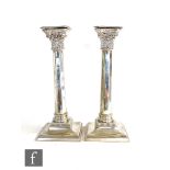 A pair of hallmarked silver candlesticks, square stepped bases below octagonal faceted columns,