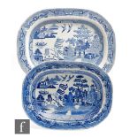 Two 19th Century blue and white meat plates decorated in the Willow pattern, the largest stamped