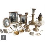 A parcel lot of assorted hallmarked silver items to include three photograph frames, flatware, a
