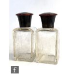 A pair of late 19th Century clear glass and tortoiseshell square cologne bottles each with