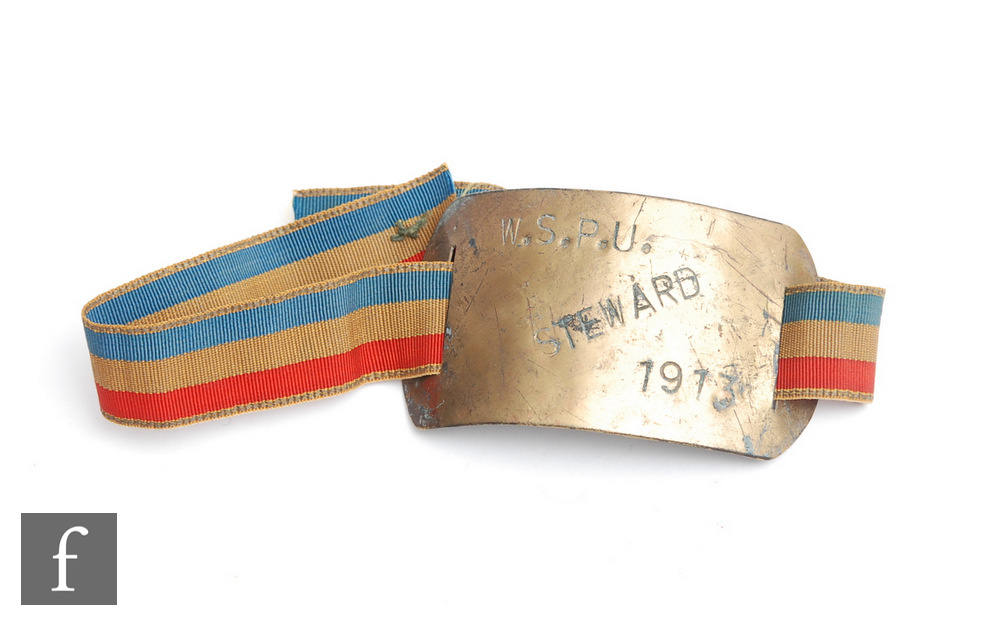 A gilt metal arm band stamped W.S.P.U STEWARD 1913, with later blue, beige and blue arm strap, width