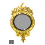 A 19th Century circular gilt wall mirror, the raised frame surmounted with a resting deer flanked by