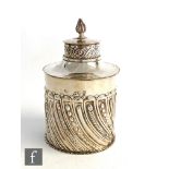 A hallmarked silver tea caddy of cylindrical part fluted form terminating in pull off lid with flame