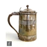 A George III hallmarked silver cylindrical tankard detailed with two reeded bands, scroll handle