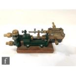 A Stuart horizontal single cylinder engine, painted in green and raised to a mahogany plinth, length