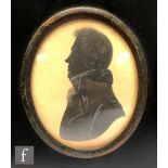 An early 19th Century painted silhouette depicting Mr James Gibson in profile, oval, framed, 8cm x