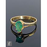 An 18ct emerald single stone ring, marquise claw set emerald to split shoulders, weight 2.8g, ring