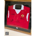 A Manchester United red and white shirt signed by five captains, Steve Bruce, Eric Cantona, Peter