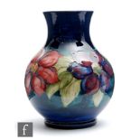 A 1950s Moorcroft vase of globe and shaft form decorated in the Clematis pattern with a band of