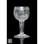 An 18th Century drinking glass circa 1740, the cup form bowl engraved with an OXO border above a