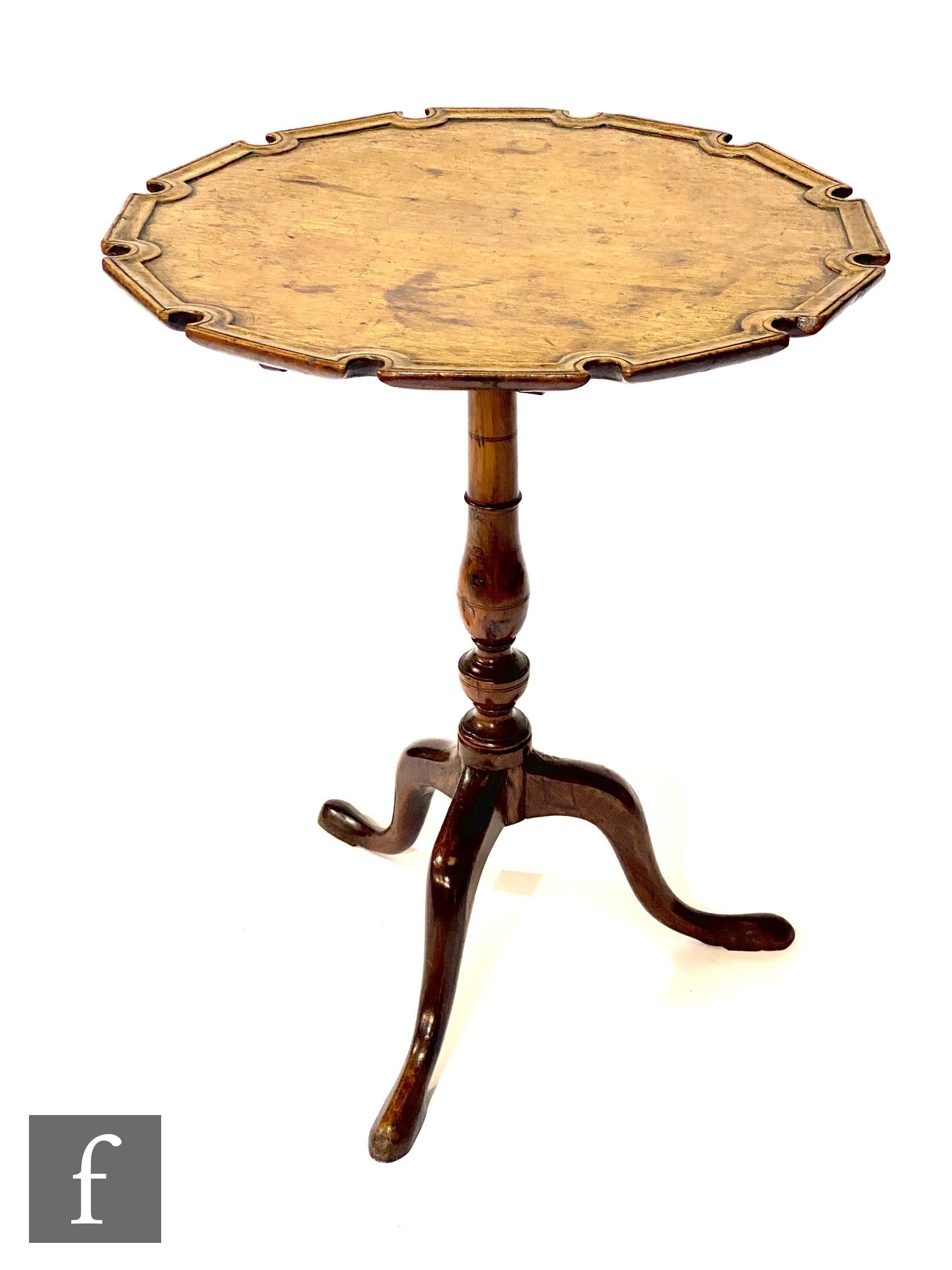 A George III mahogany snap top tripod occasional table, the raised moulded edge shaped top on turned