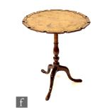 A George III mahogany snap top tripod occasional table, the raised moulded edge shaped top on turned