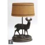 A stag table lamp, the stepped oval base surmounted by a stag in standing position, with all over