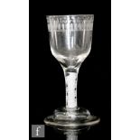 An 18th Century drinking glass circa 1775, the ogee bowl engraved with a daisy border above a
