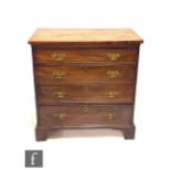 A George III mahogany straight front chest of four long cock beaded graduated drawers, brass fret
