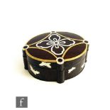 An oval hardwood (possibly palm wood) trinket box and cover, inlaid with silver and brass and