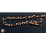 An early 20th Century 9ct rose gold open curb link Albert chain, terminating in T bar and end