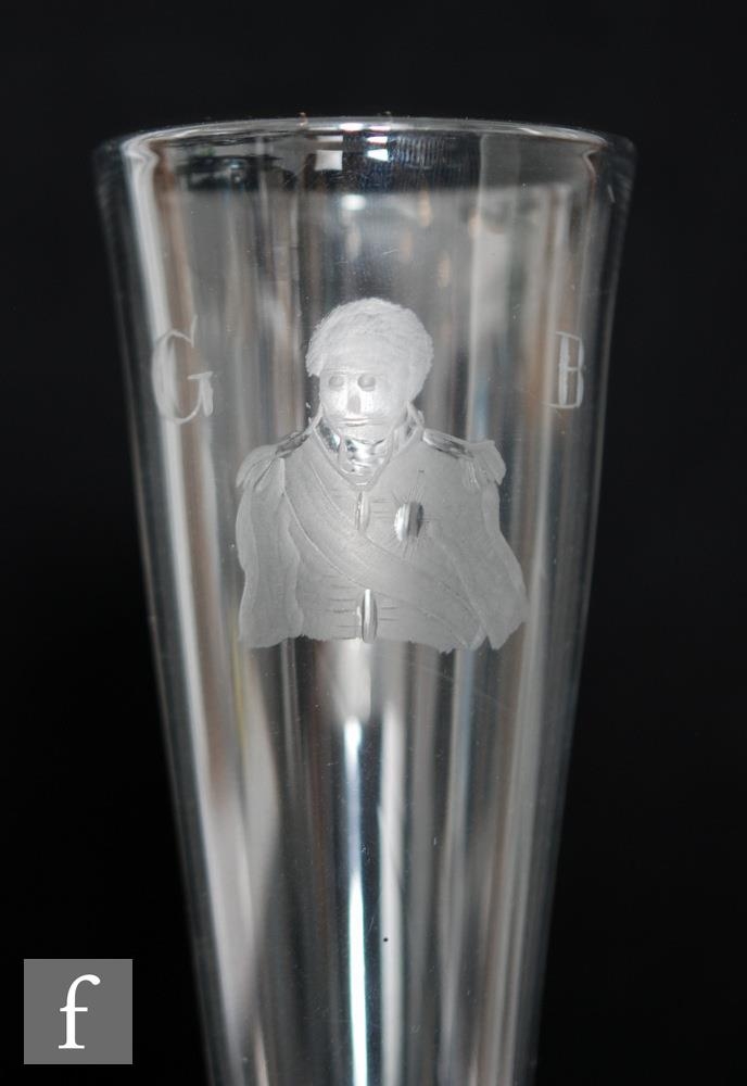 An 18th Century drinking glass, the over sized tall funnel bowl engraved with a portrait of