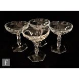 A set of four 20th Century drinking glasses, each with a coupe bowl with facet cut decoration over