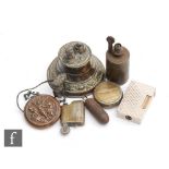 An Edwardian embossed pressed brass chamberstick table lighter, another with a zeppelin and a