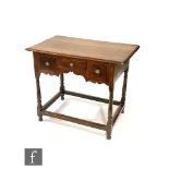 An 18th Century style oak lowboy, the moulded edge top above three short drawers and a shaped apron,