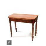 A 19th Century mahogany fold-over tea table of rounded rectangular form, raised to turned legs,