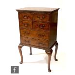 A George III style small mahogany chest of four short and two long drawers, brass swan neck drop