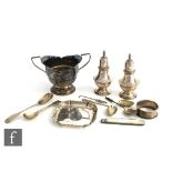 A small parcel lot of assorted hallmarked silver items to include two peppers, a twin handled sugar,