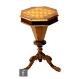 A Victorian marquetry inlaid octagonal sewing table with chequer board top, on trumpet pedestal base